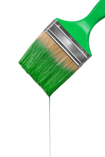A paintbrush dripping with green paint - Zdjęcie, obraz