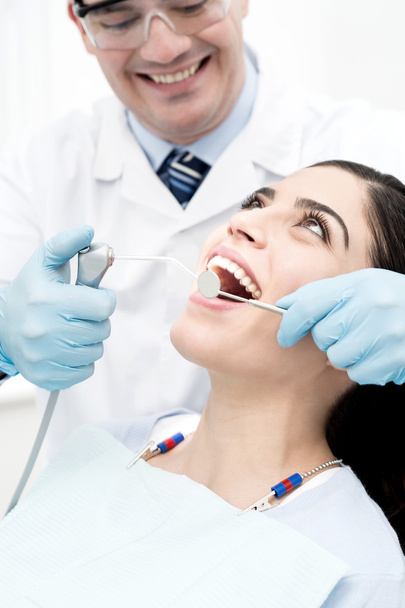 Patient getting her teeth treated - Foto, Imagen