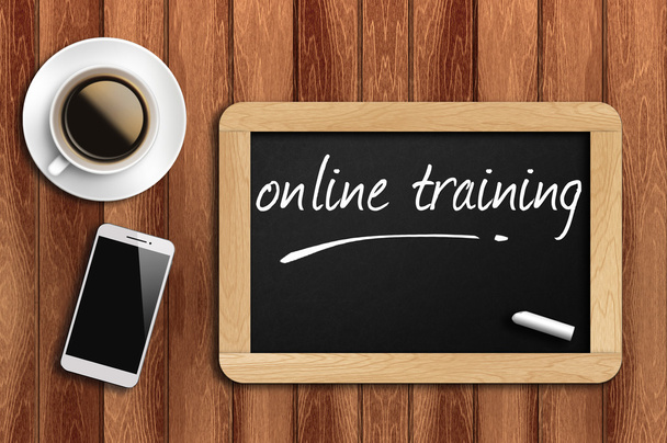 coffee, phone  and chalkboard with  word online training - Фото, изображение