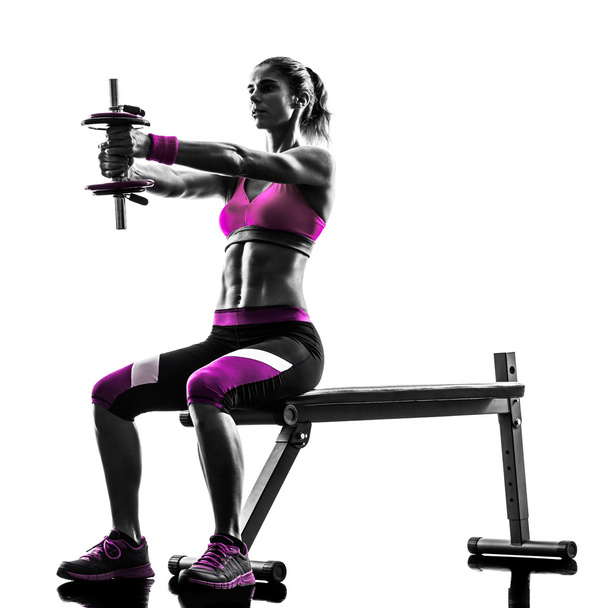 woman exercises weights - 写真・画像
