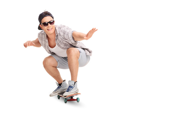 Young joyful skater riding a skateboard  - Fotoğraf, Görsel