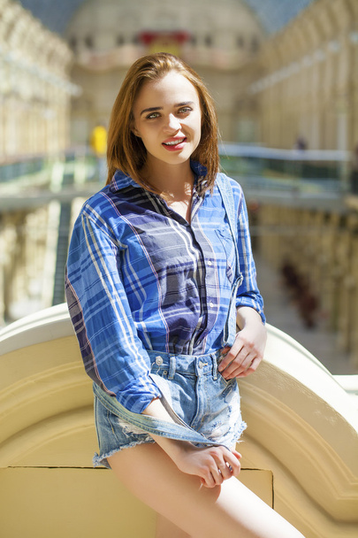 Close up of young beautiful woman in a checkered blue shirt - Foto, Imagen