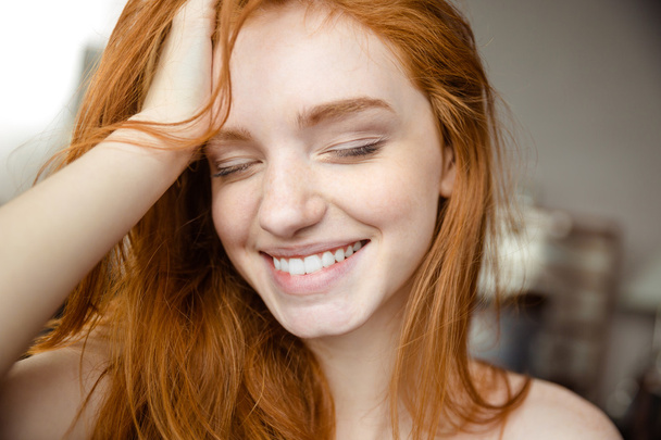 Smiling redhead woman with closed eyes  - Photo, Image