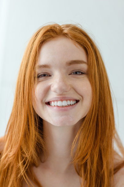 Smiling redhead woman looking at camera - Photo, image