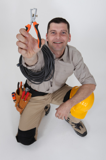 An electrician holding a wire stripper. - Photo, Image