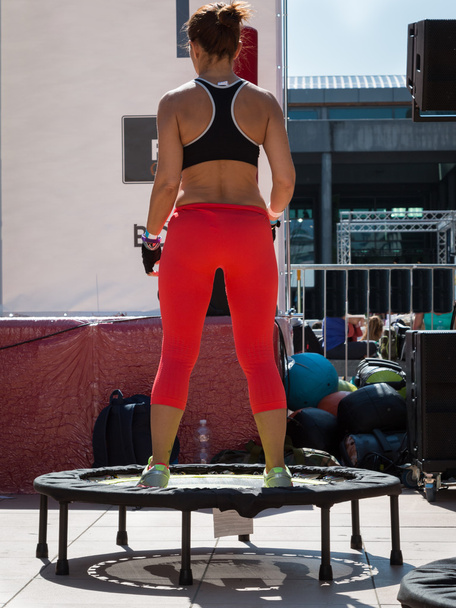 Mujer con ropa deportiva roja haciendo fitness en mini trampolín
 - Foto, imagen