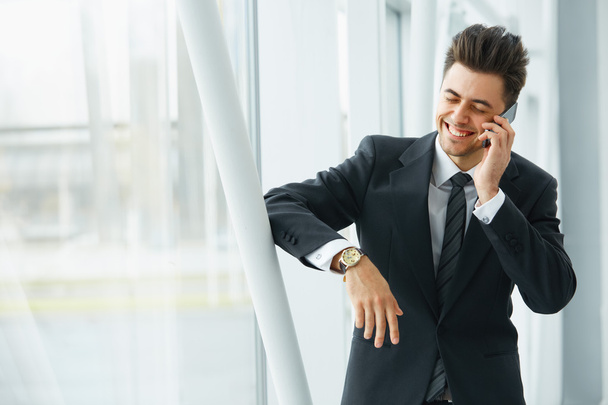 Businessman Talking on the Phone and Smiling - Фото, изображение