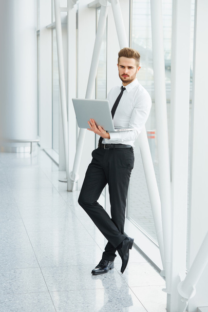 Businessman with laptop. Young Businessman Typing Something on L - Foto, Bild
