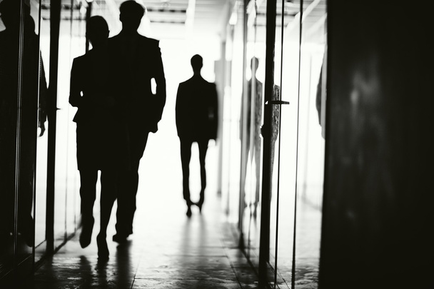Outlines of business people walking - Foto, afbeelding