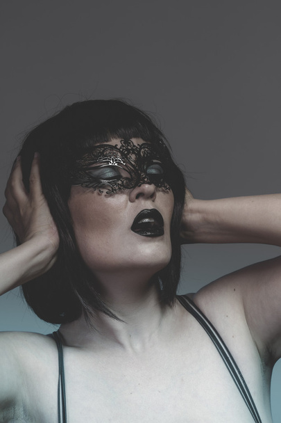 Woman in black mask with thread - Photo, Image