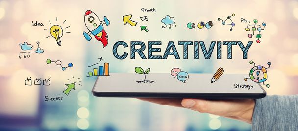 Creativity concept with man holding a tablet  - Photo, Image
