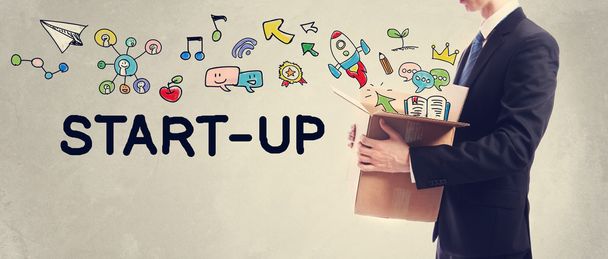 Start-Up concept with Businessman holding a box - Фото, изображение