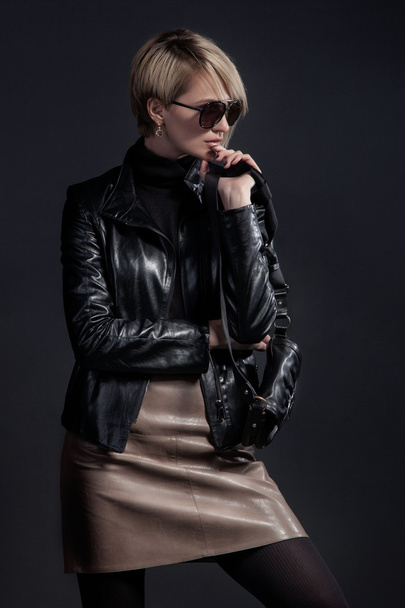 Fashion photo of beautiful lady in leather jacket and slirt with - Fotó, kép