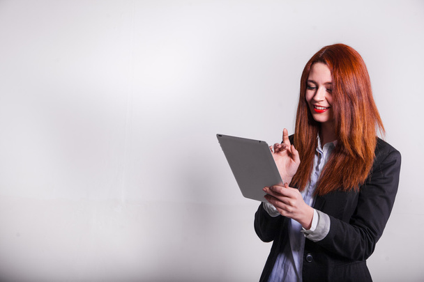 red businesswoman showing tablet isolated over white - Photo, Image