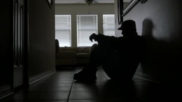 Soldier's silhouette rests against the hallway wall battling PTSD, MEDIUM, 4K - Footage, Video