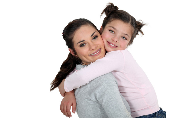 Mother and daughter hugging - 写真・画像
