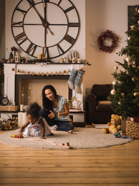 mother and daughter playing at Christmas time - 写真・画像
