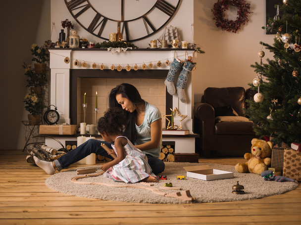 mother and daughter playing at Christmas time - Фото, изображение