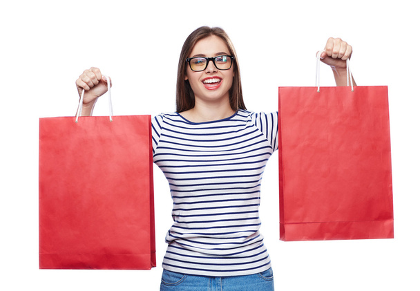 Mulher com sacos de compras vermelhos
 - Foto, Imagem