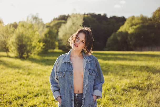 Stylish naked girl in the denim outdoor - Photo, Image
