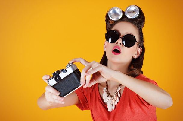 Young attractive fashionable surprised woman with old-school camera - Zdjęcie, obraz