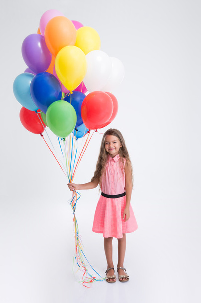 Pretty little girl standing with balloons - Foto, Imagem