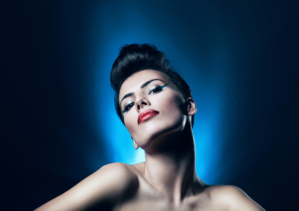 Attractive brunette woman with red lips in blue light - Fotoğraf, Görsel