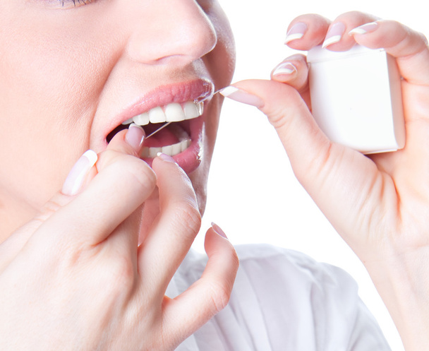 Young woman flossing teeth - Foto, Bild