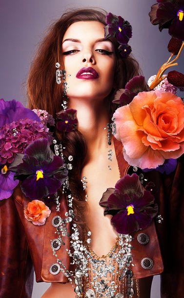 Erotic woman with silver accessory in flowers - Foto, Bild