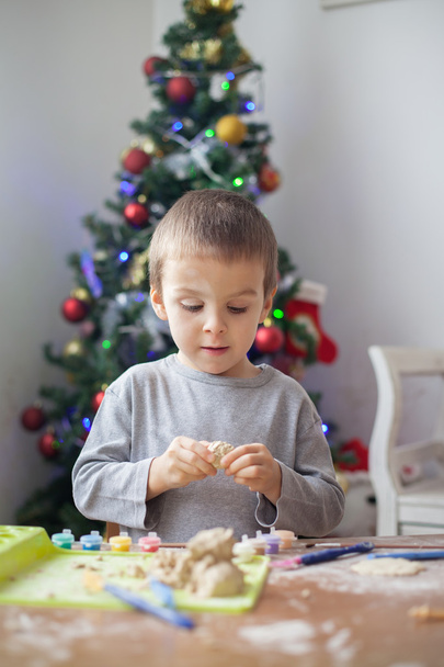 Cute little boy, playing with modeling dough, molding figures at home on Christmas - Fotoğraf, Görsel