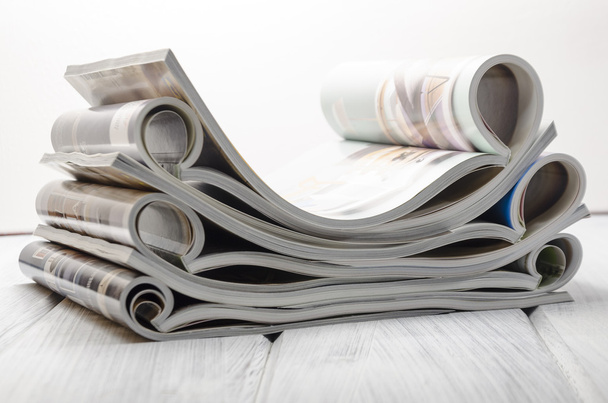 stack of magazines on a white wooden background - Photo, Image