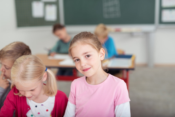 Smiling young girl in the classroom at school - Foto, Bild