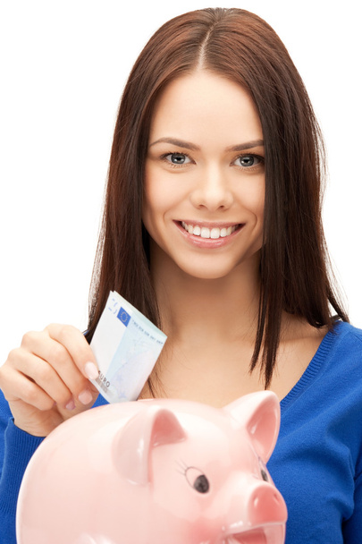 Lovely woman with piggy bank and money - Valokuva, kuva