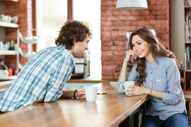 Young couple enjoying coffee in cafeteria - Foto, Bild