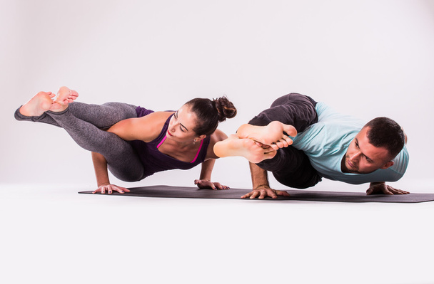 Young healthy couple in yoga position - Фото, изображение