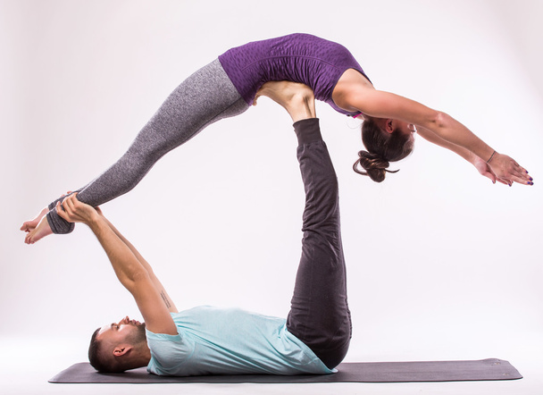 Young healthy couple in yoga position - Фото, изображение