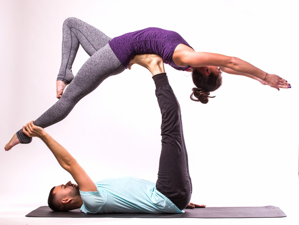 Young healthy couple in yoga position - 写真・画像