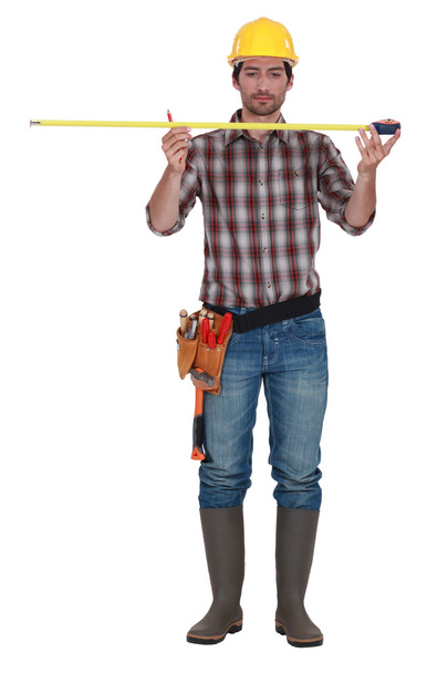 Builder with a tape measure - Foto, Imagen