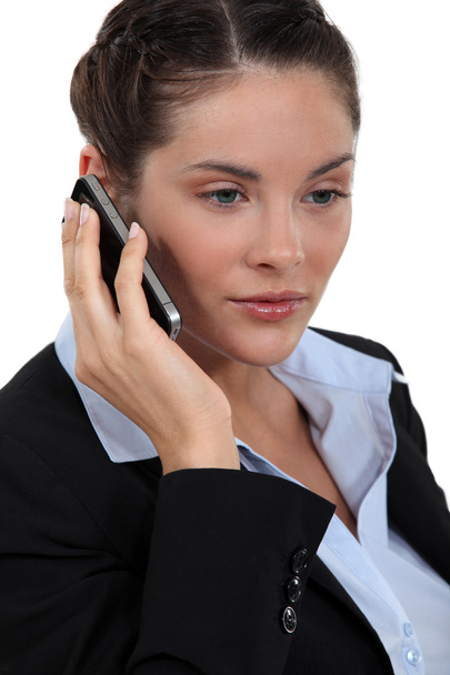 Businesswoman on mobile telephone - 写真・画像