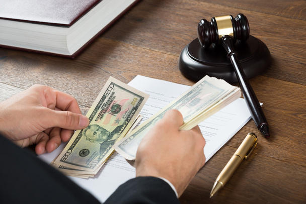 Corrupt Judge Counting Money At Desk - Foto, Imagen