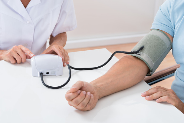 médico verificando a pressão arterial do paciente
 - Foto, Imagem