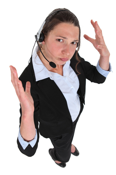 Receptionist with earphones looking exasperated - Photo, Image