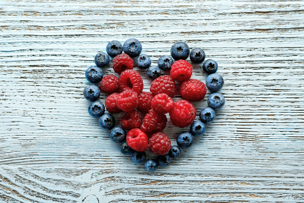 Heart shaped raspberries and blueberries - Fotoğraf, Görsel