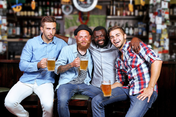 Young men in bar - Фото, зображення