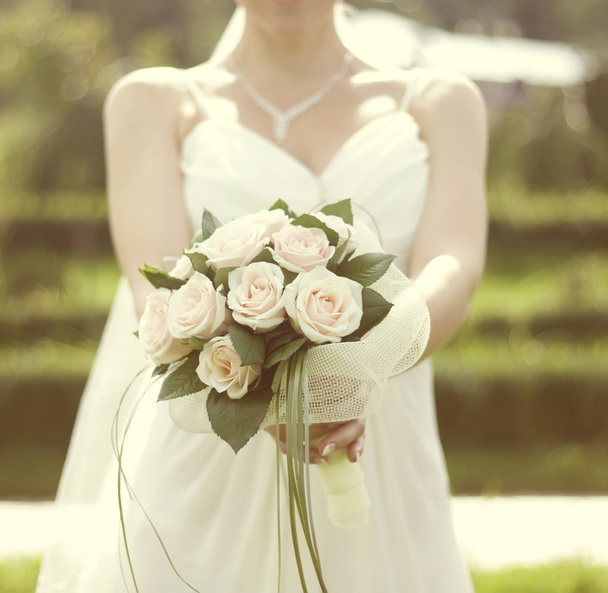 Pink and white wedding bouquet of roses in the hands of the brid - Zdjęcie, obraz