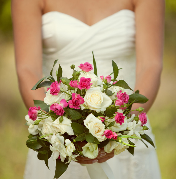 Pink and white wedding bouquet of roses in the hands of the brid - Zdjęcie, obraz