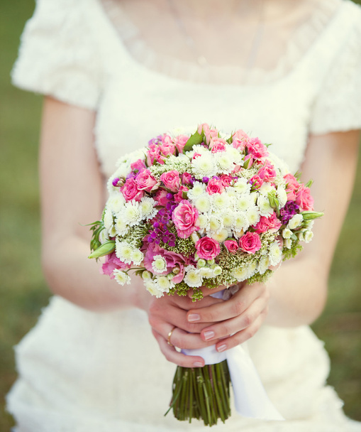 Pink and white wedding bouquet in the hands of the bride - Photo, image