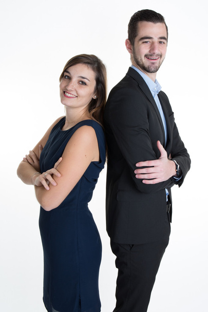 Smiling sales team with arms folded standing back to back isolated - Photo, Image