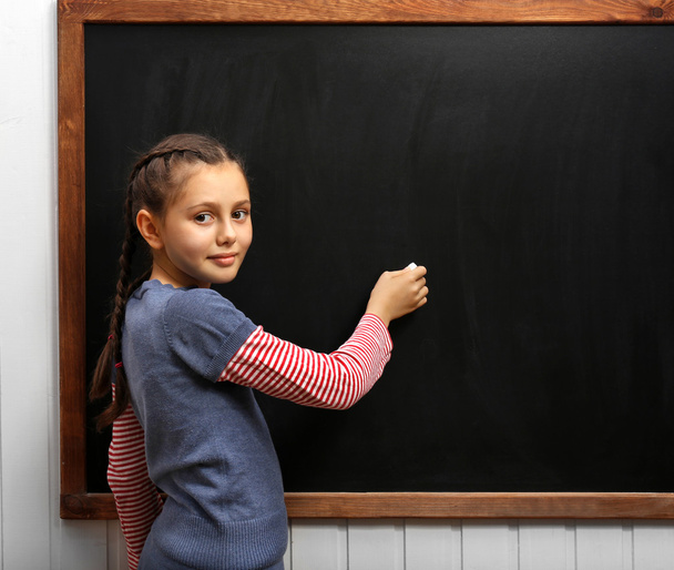 girl posing at clean blackboard - Фото, зображення
