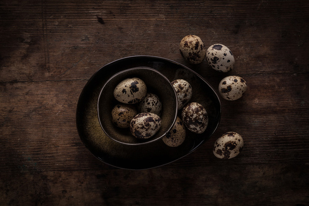 Quail eggs on pottery bowls - Foto, afbeelding